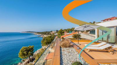 an aerial view of a house overlooking the ocean