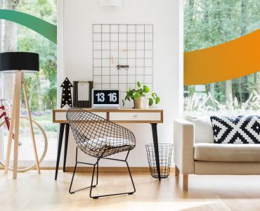 a living room with a couch, chair and a desk