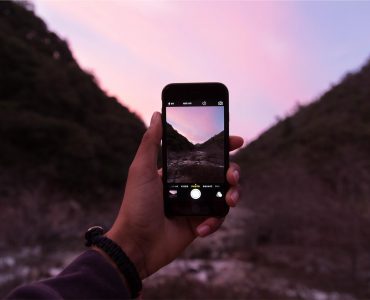 a person taking a picture with their cell phone