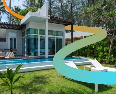 a modern house with a pool and lounge chairs