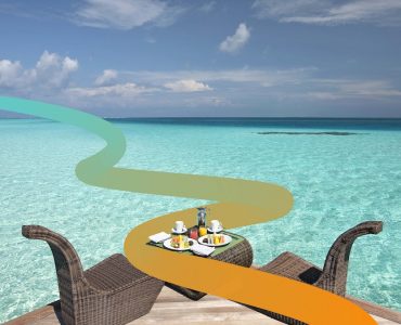 a couple of chairs sitting on top of a beach