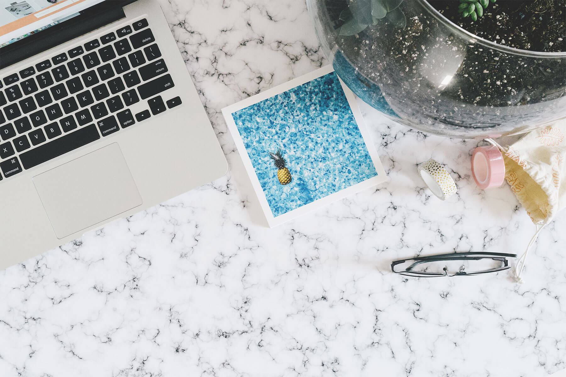 a laptop computer sitting on top of a marble counter