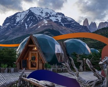 a wooden cabin with mountains in the background