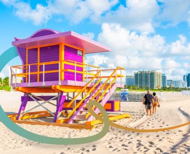 a lifeguard tower on a beach with a city in the background