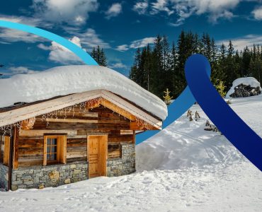 a cabin in the snow with a blue ribbon in front of it
