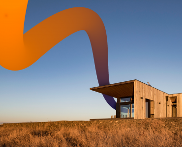a house on a hill with a large orange wave coming out of it