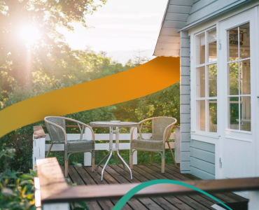 a table and chairs on a wooden deck