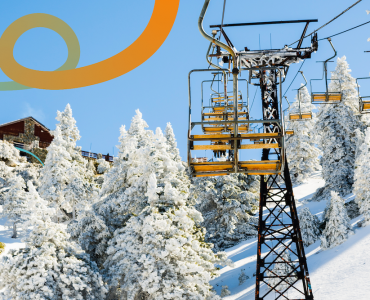 a ski lift going up a snowy mountain