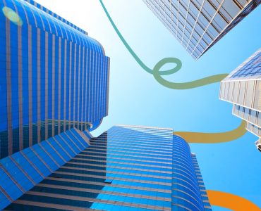 a group of tall buildings with a sky background