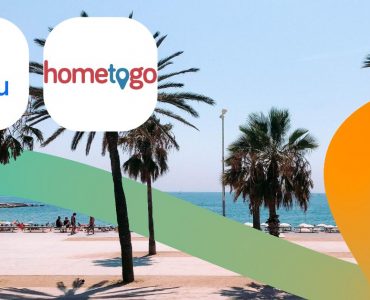 a beach with palm trees and a sign that says home to go