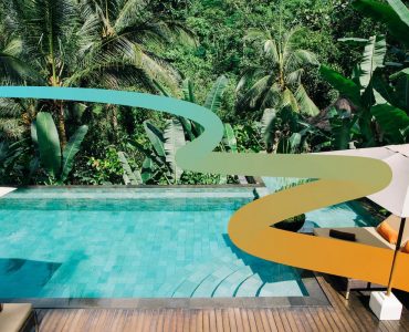 a pool surrounded by palm trees and umbrellas