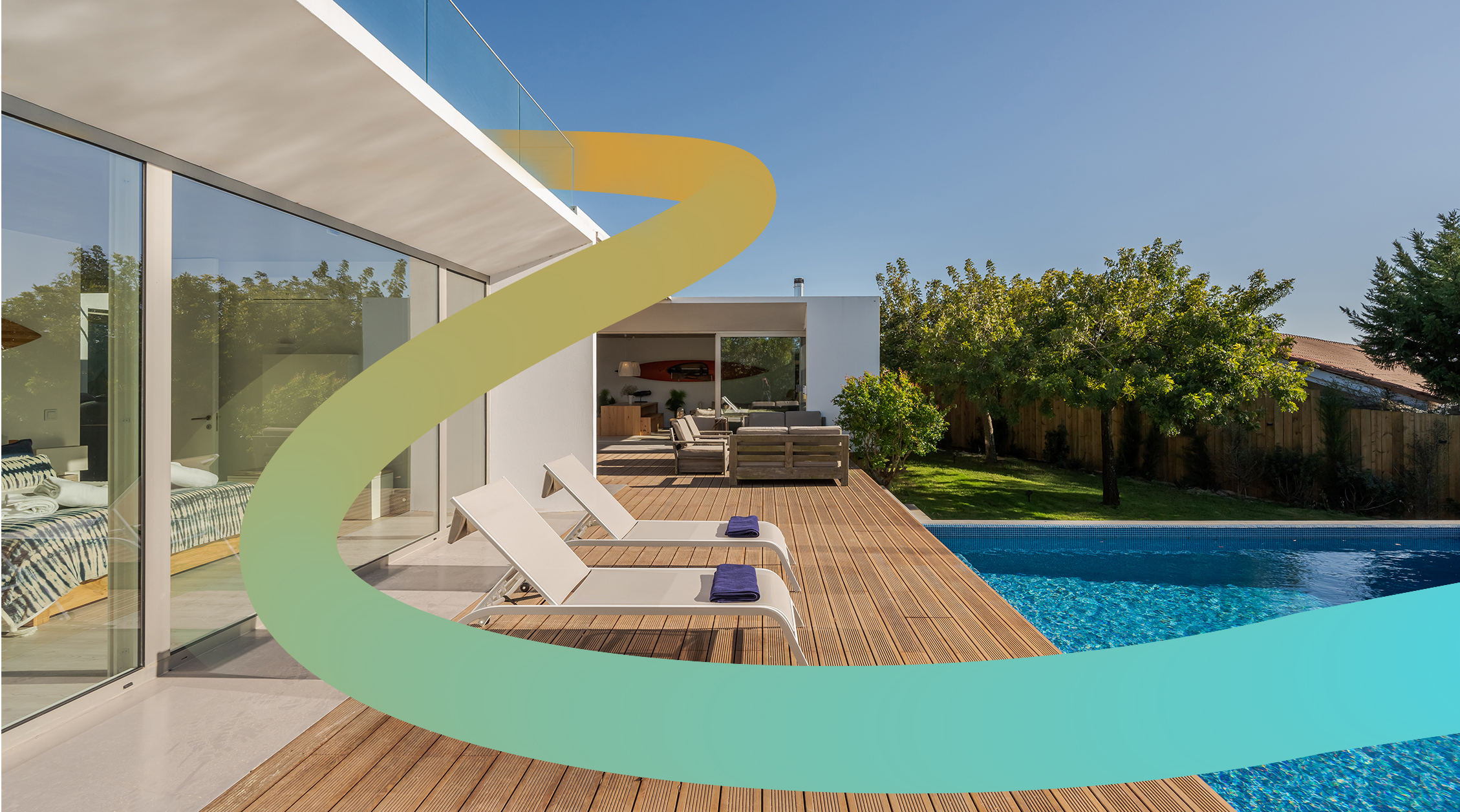 a house with a swimming pool and lounge chairs