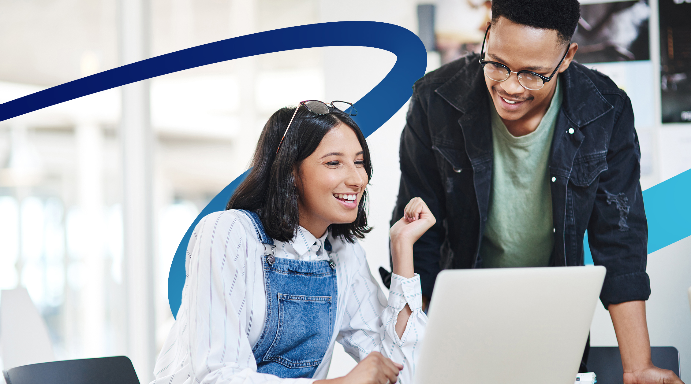 a man and a woman looking at a laptop