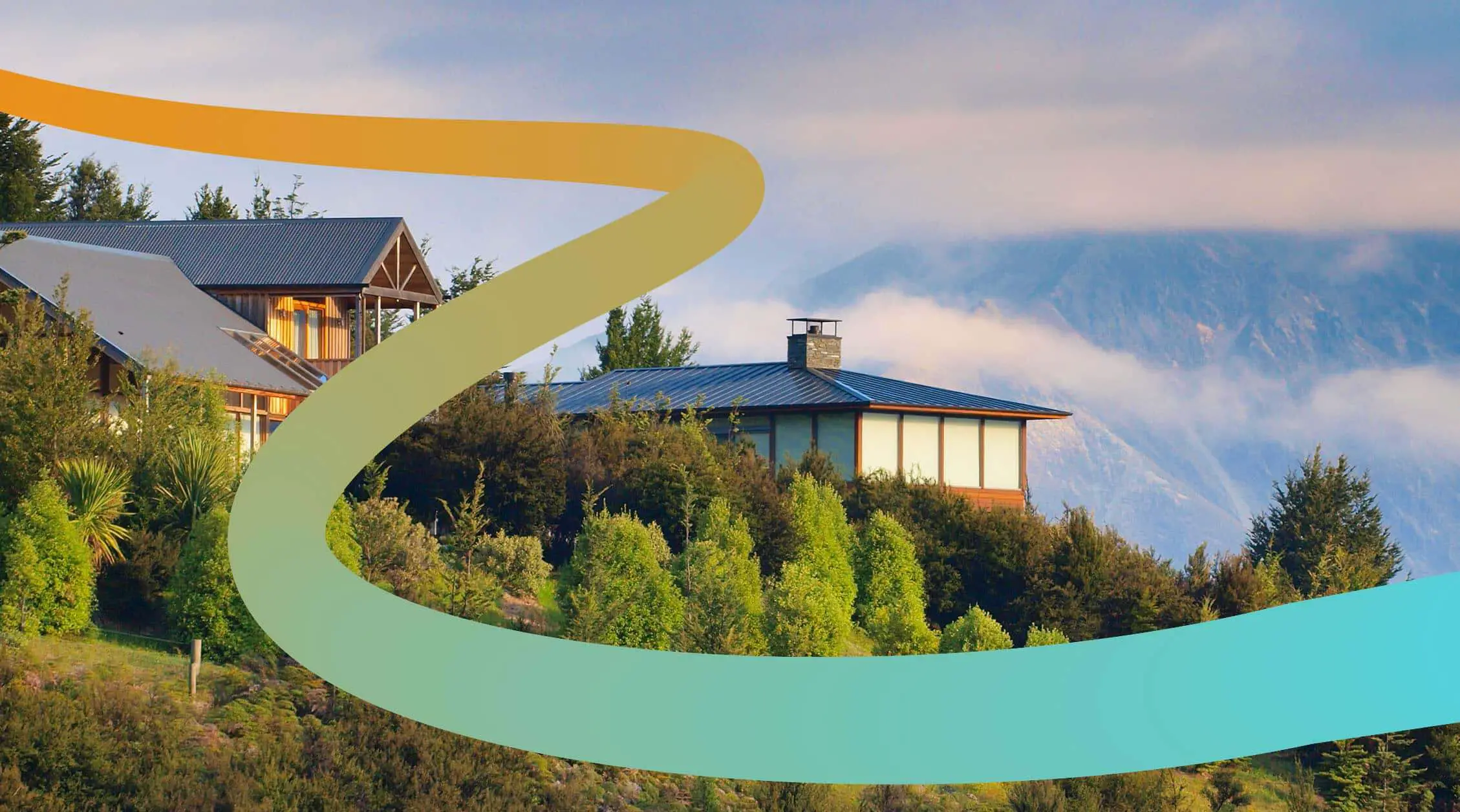 a picture of a house on a hill with mountains in the background