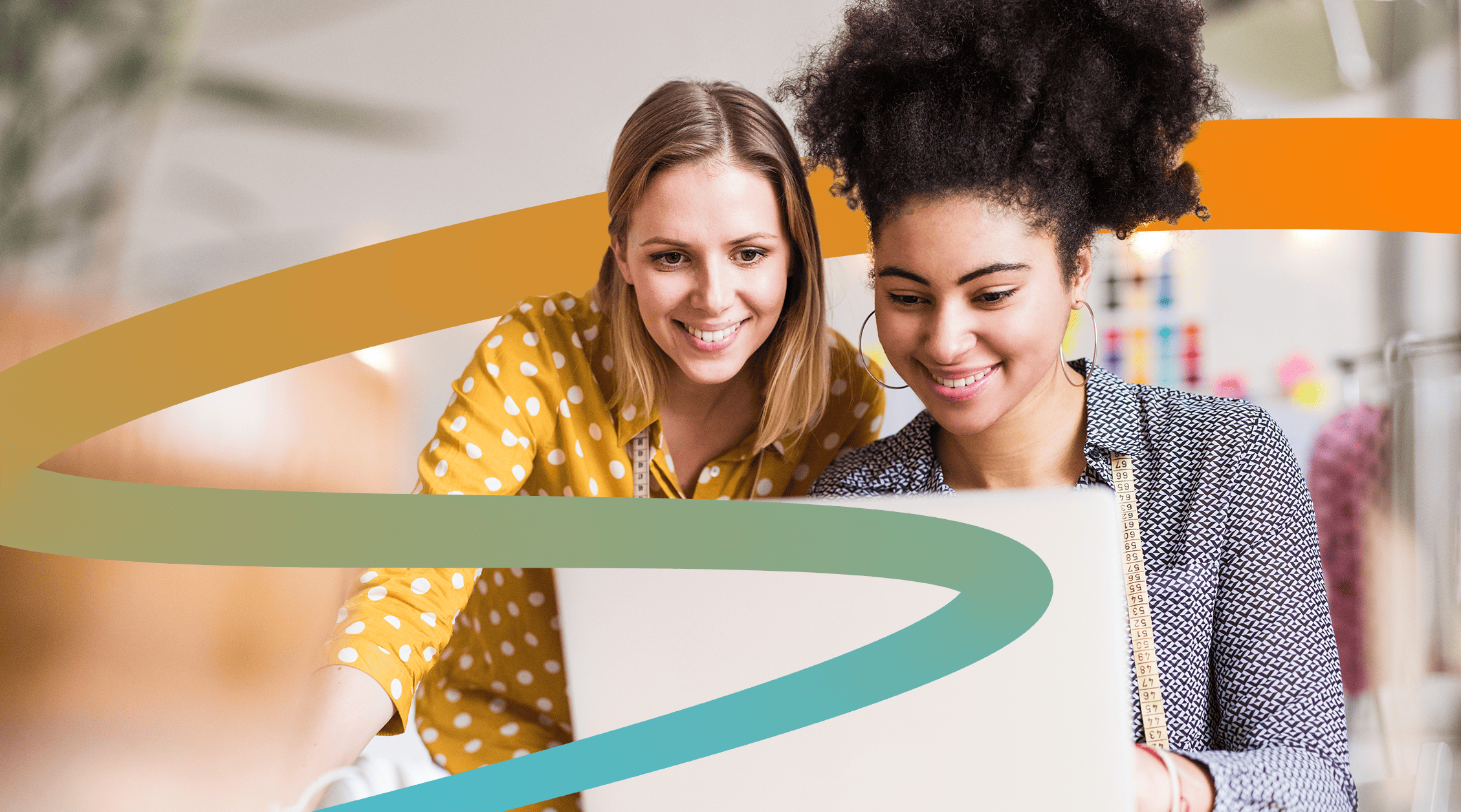 two young women looking at a laptop screen